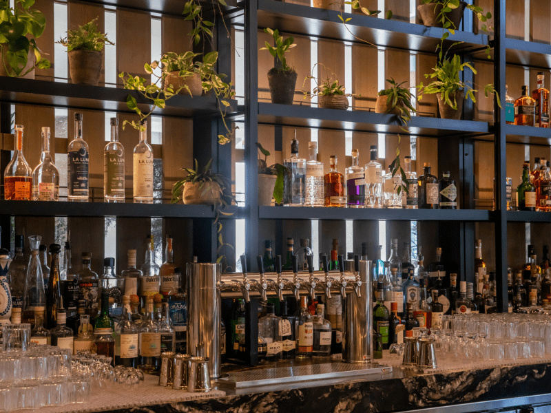 Bar shelves lined with various spirits