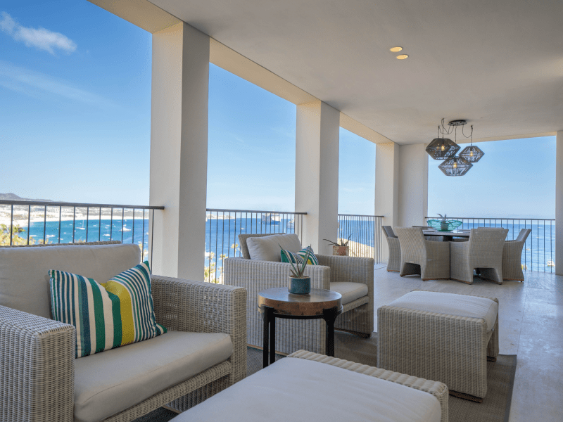 Balcony with several lounge chairs overlooking the ocean