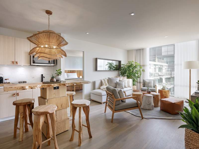 A 1 Hotels suite with full kitchenette, living room area, and bedroom