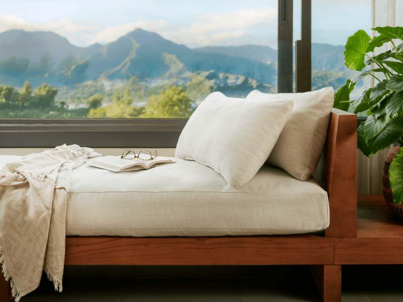 Pair of glasses resting on a book on a lounge chair