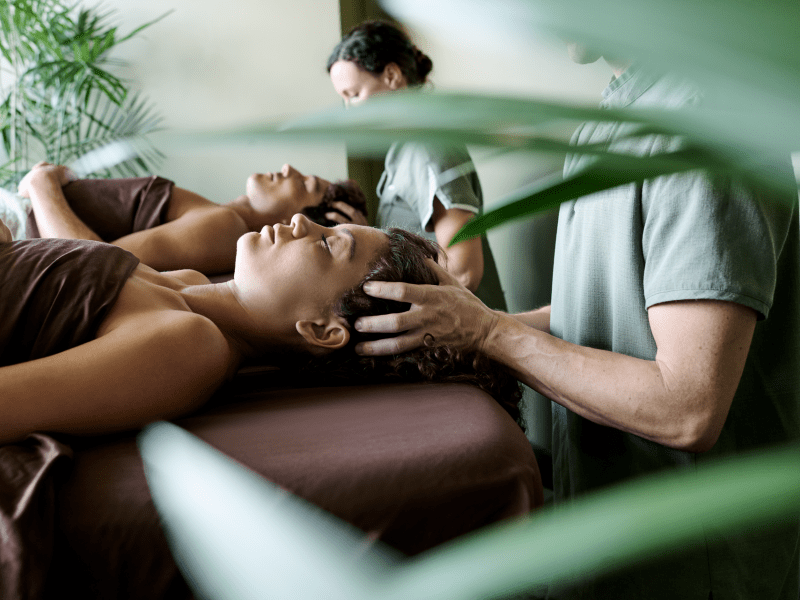 Two people enjoying a scalp massage 