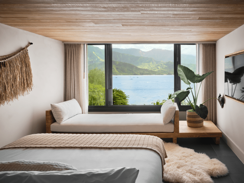 A hotel room with a view of the ocean just outside