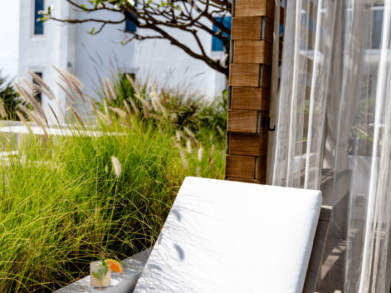 Cabana lounge chair with a hat and cocktail