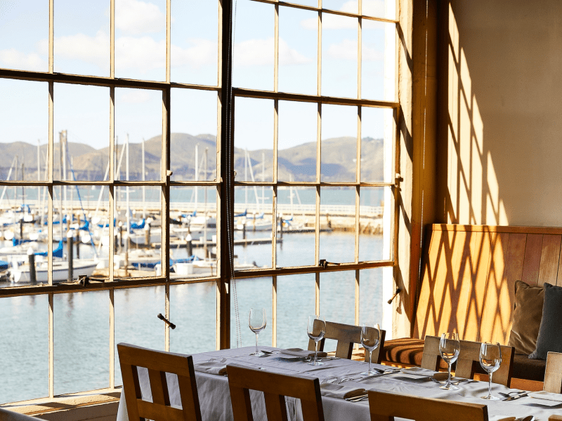 Set dining table next to a window
