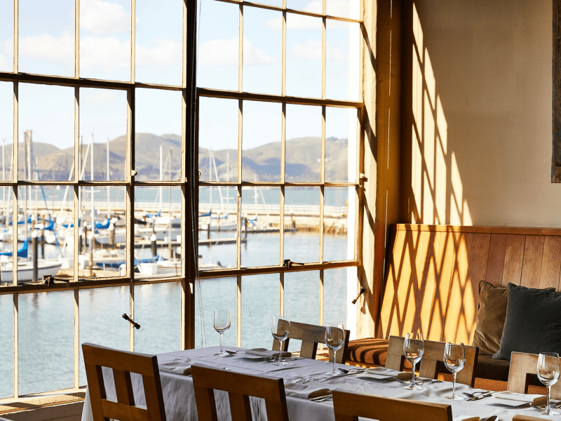 Set dining table next to a window