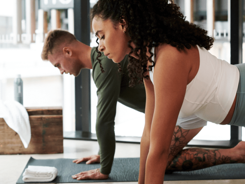 Two people doing yoga