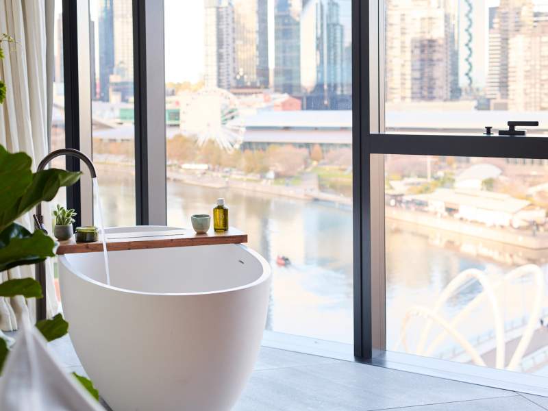 Modern white bathtub with a large window
