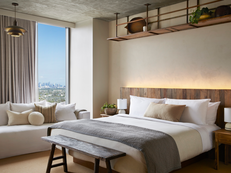 A king size bed with a white sofa adjacent 