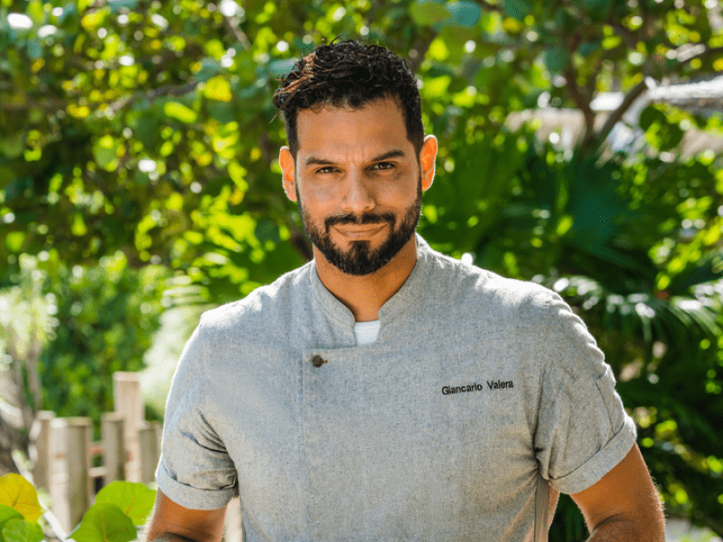 Chef Giancarlo Valera holding a skillet of breakfast food