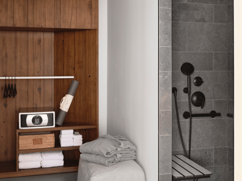 Wood paneled wall with a grey tile shower