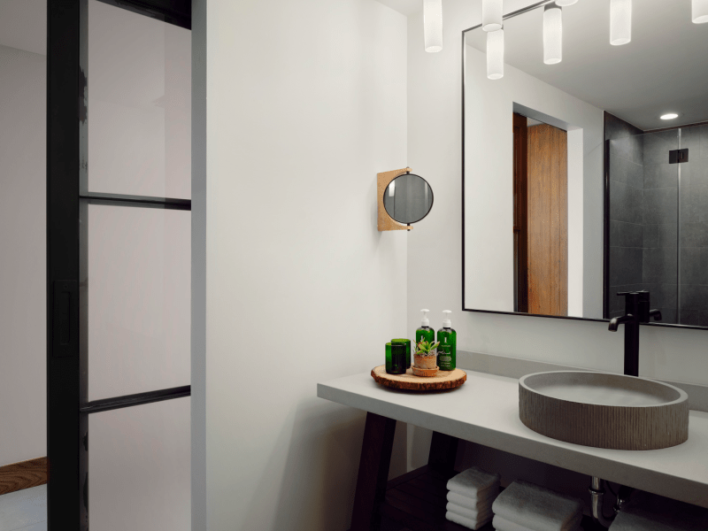 Bathroom sink with rotating side mirror