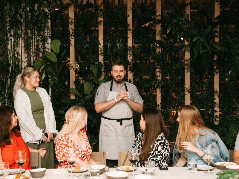 a chef speaking with diners