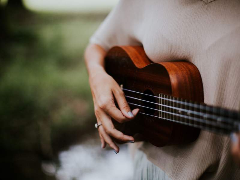 Person playing a ukulele