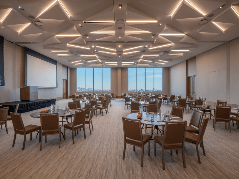 Conference room with circular tables and wide rectangular windows