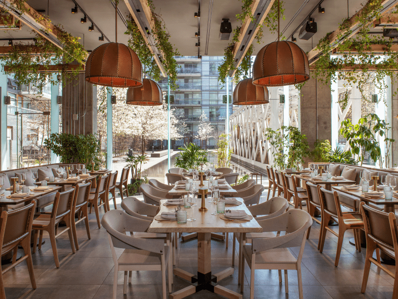 Dining area with greenery hanging from ceiling