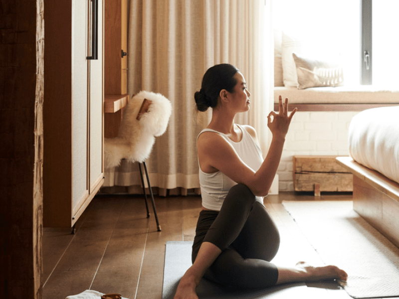 Woman doing yoga in her room 