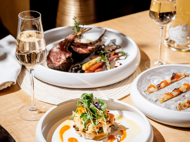 Plates of food with two glasses of wine