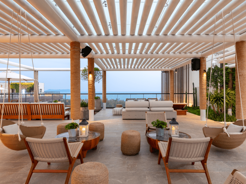 Seating area with hanging chairs and a view of the ocean