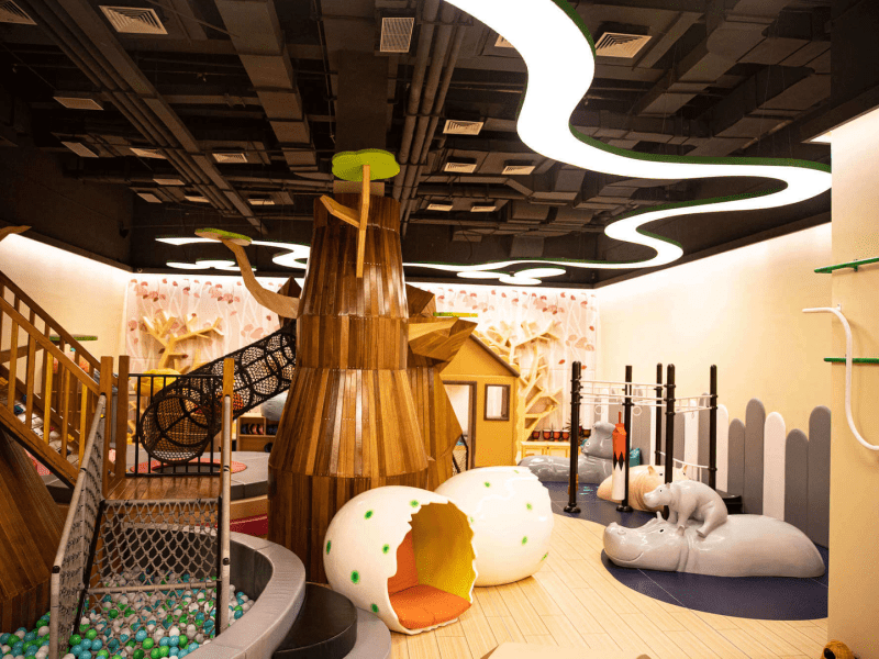 The children's play room inspired by nature, complete with ball pit, slide, and hanging rings