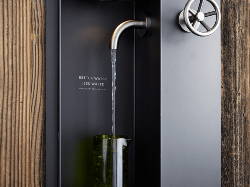 A water filter hydration station with a caption that says Better Water, Less Waste