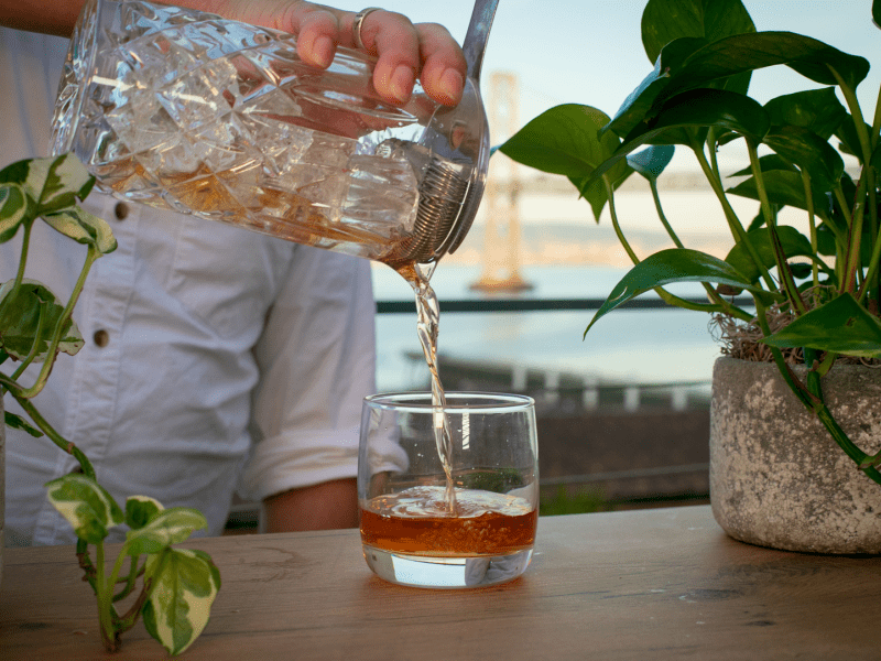 Cocktail being poured on rooftop