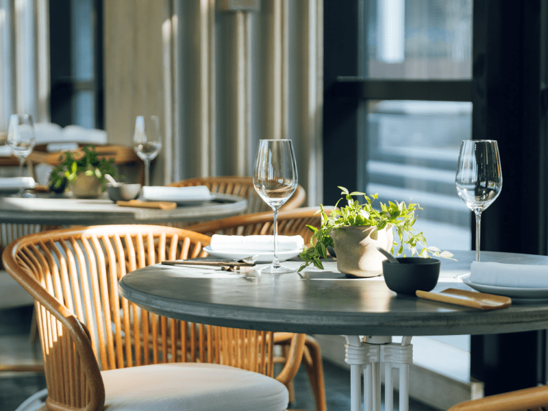Green House tables in front of a window