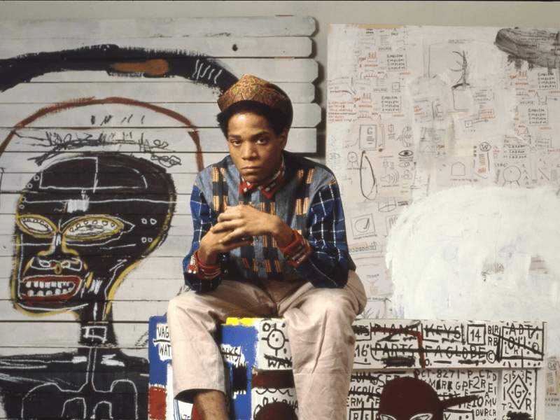 Basquiat in front of artwork