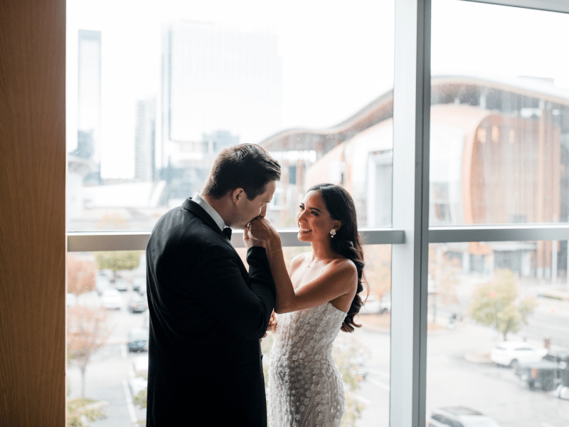 a woman and man in front of a window