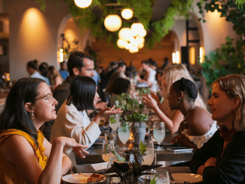 A lengthwise shot of the Terrene restaurant with full tables of people enjoying good food and company