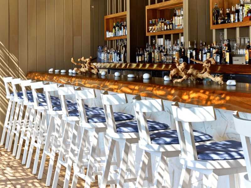 Chairs lined up at a bar