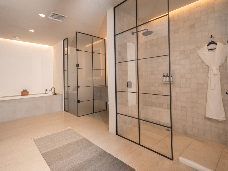 Modern bathroom with glass paneled showers