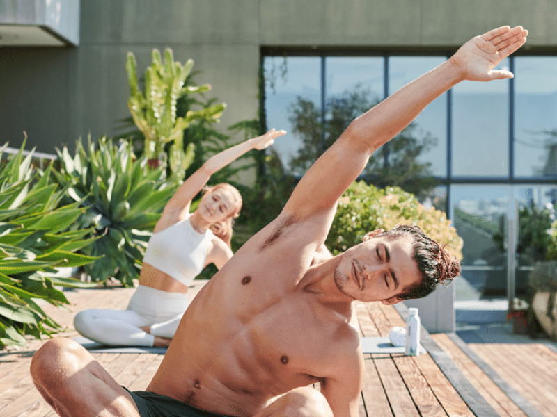 Man leads a yoga practice on the skydeck at 1 West Hollywood