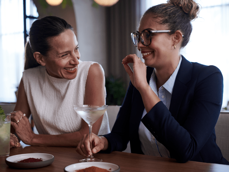 Two people chatting at a bar