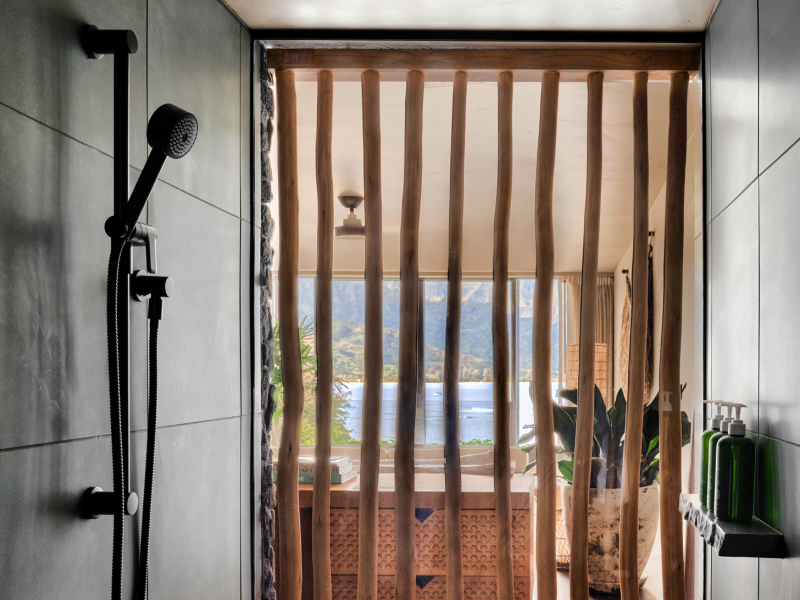 Bathroom shower area with a decorative bamboo door