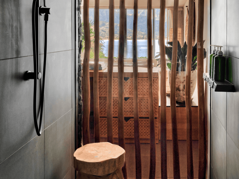 Bathroom shower area with a decorative bamboo door