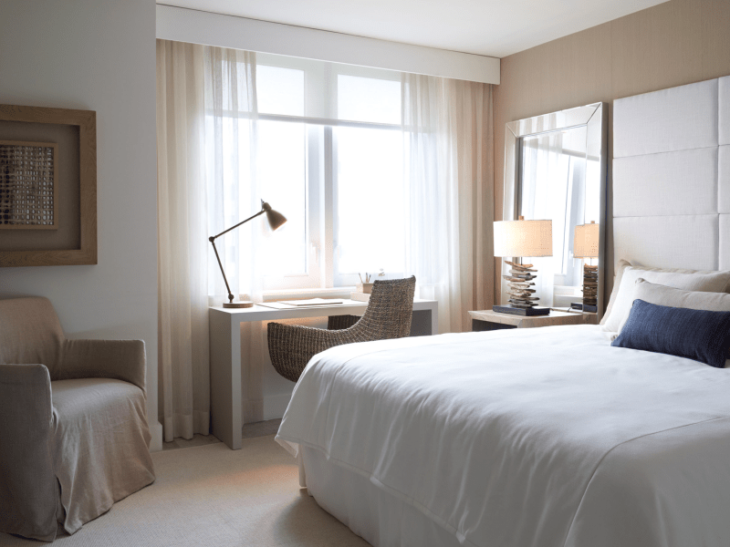 A desk with a lamp in a bedroom