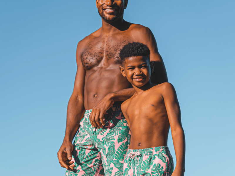 A father and son wearing matching swim suits