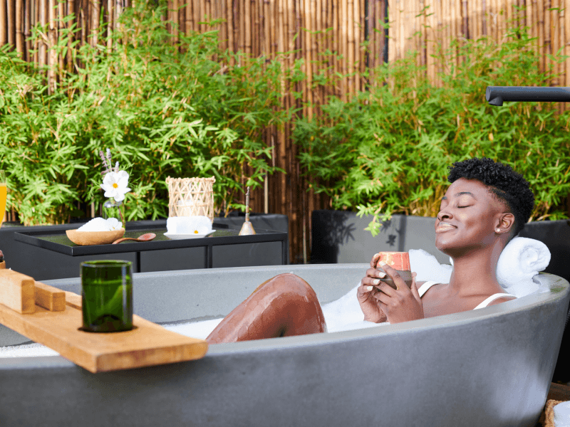 Person relaxing in an outdoor bathtub