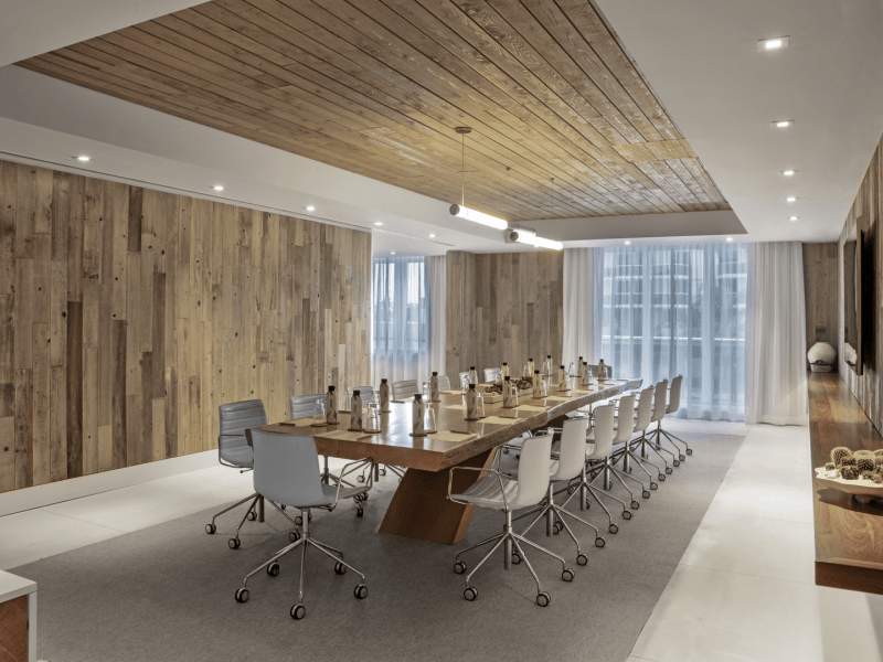 A conference room with a desk and chairs