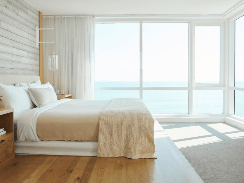 Sunny bedroom with tan colored bedspread