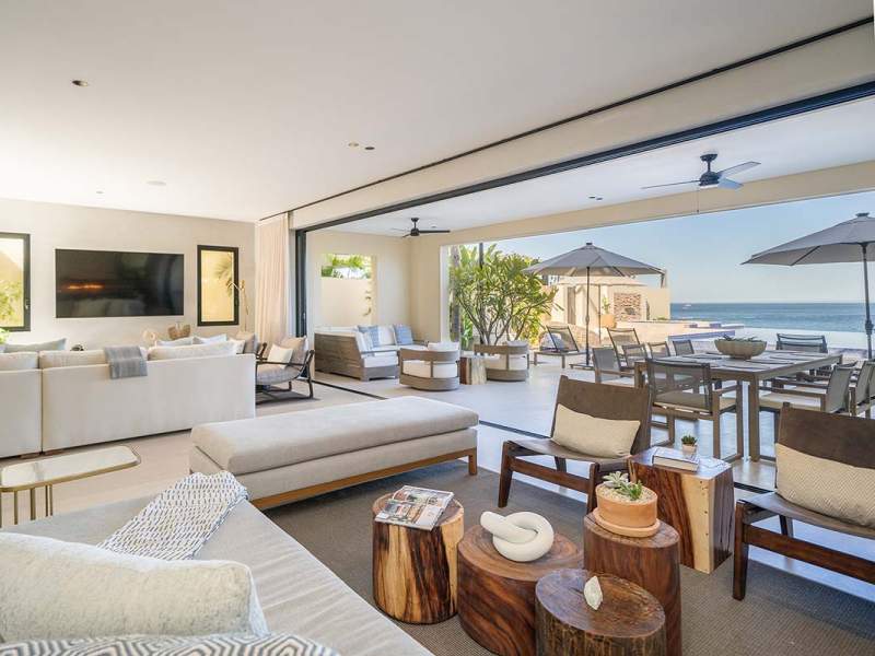 A large living room with a sectional couch and benches