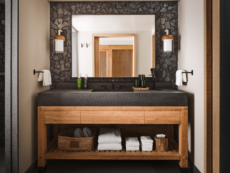 A bathroom with necessary amenities stocked on the shelf