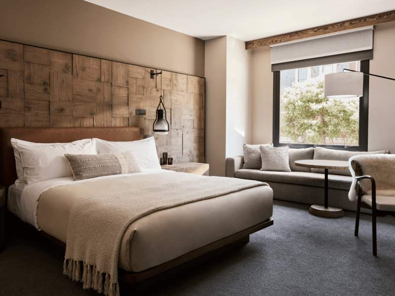 Dark colored hotel room with a large bed