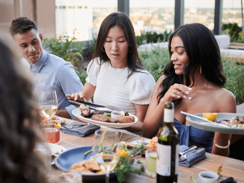 three people eating at a restaurant