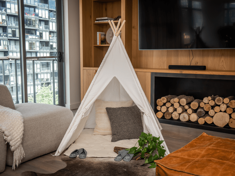 A small canvas tent set up in a living area of a suite at 1Hotel