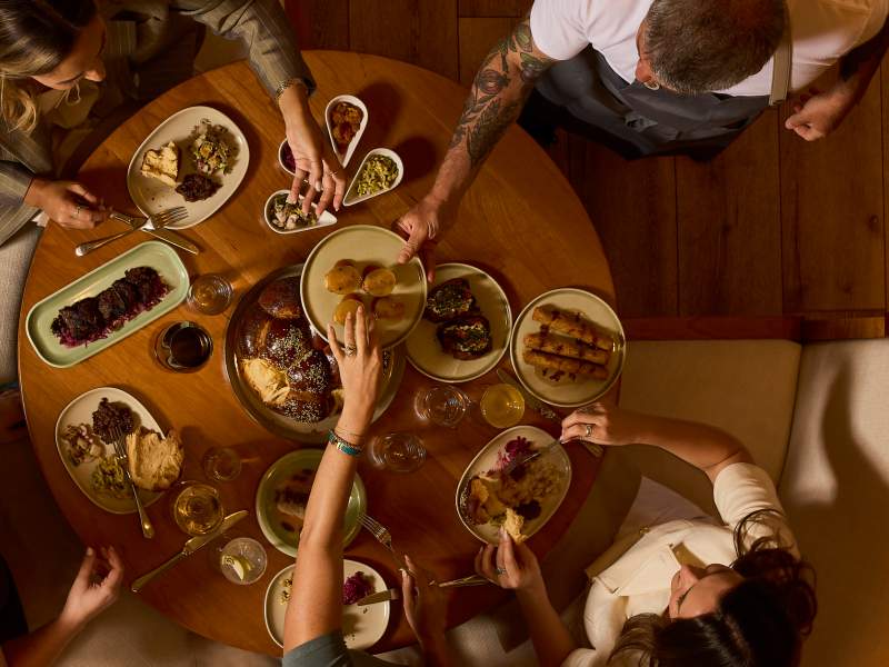 People sharing food at a round table