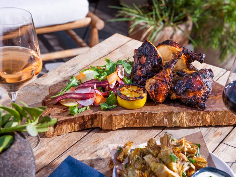 Chili marinated half chicken on a wood slab