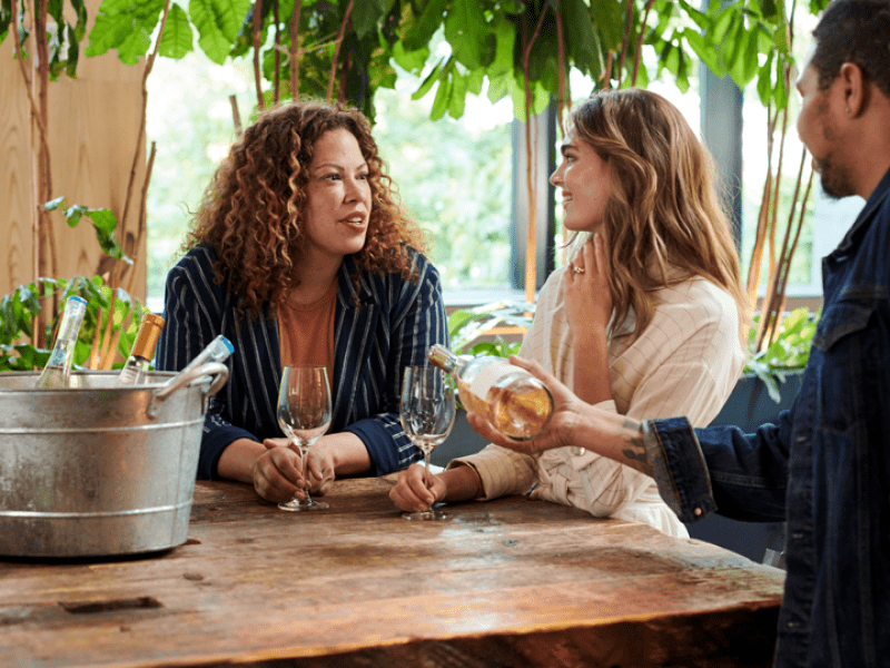 Two girls at a table enjoying wine