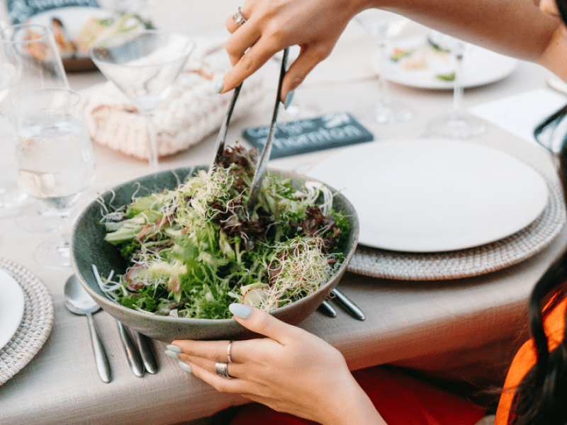 a person serving salad