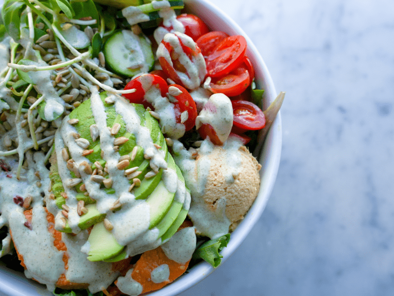 Salad topped with white dressing